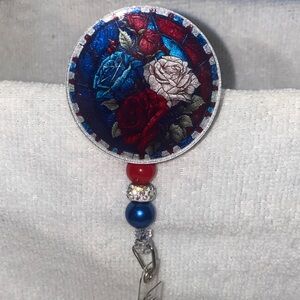 Floral Badge Reel with Red, Blue, and White Roses